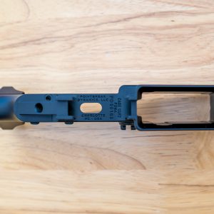 Bottom view of Pointbreak Dynamics PDM4 lower receiver showing trigger guard engravings, flared magwell, CAGE code, and serial number.