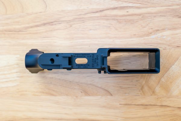 Bottom view of Pointbreak Dynamics PDM4 lower receiver showing trigger guard engravings, flared magwell, CAGE code, and serial number.